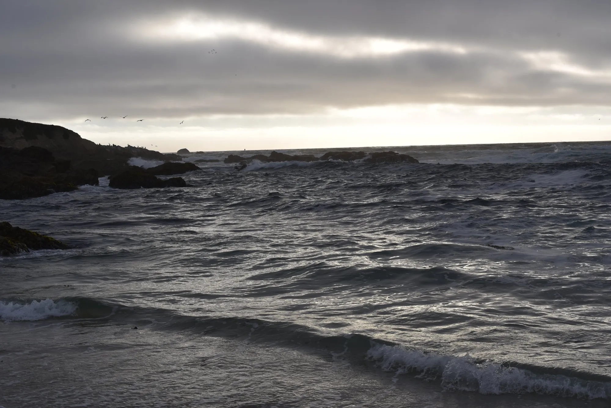 Grey Pacific swell under a low evening sky