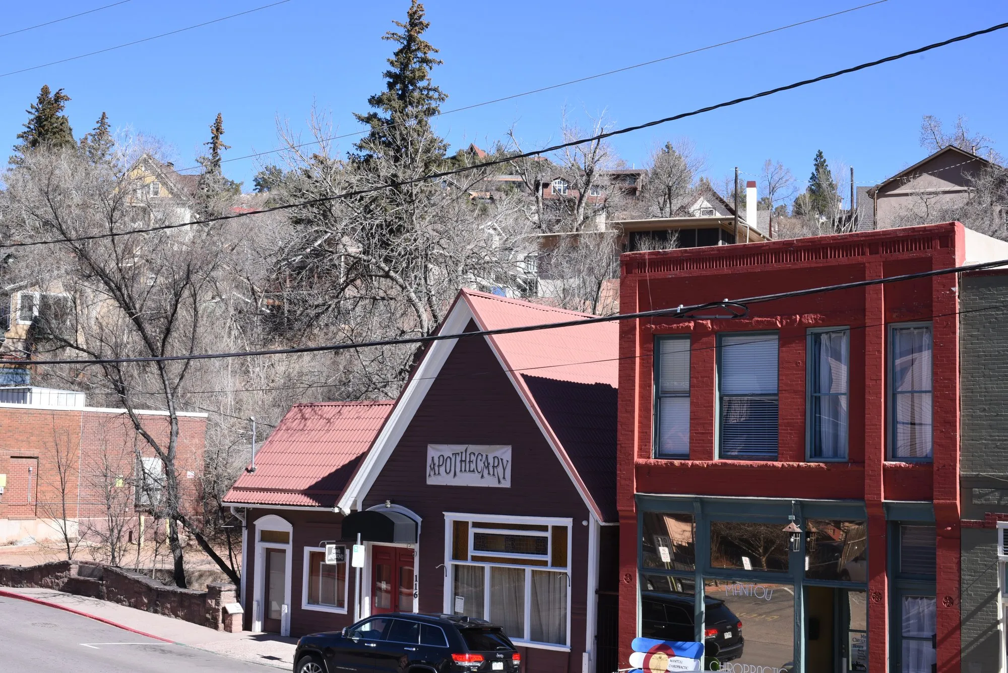 Red brick storefronts on a quiet main street in Manitou Springs